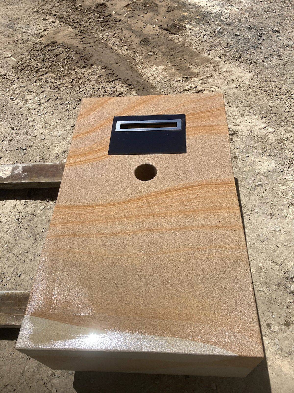 Formal sandstone letterbox angle view showing natural stone tones