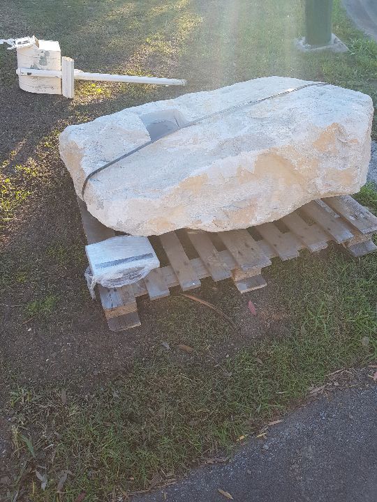 Rustic sandstone letterbox detail showing natural stone grain
