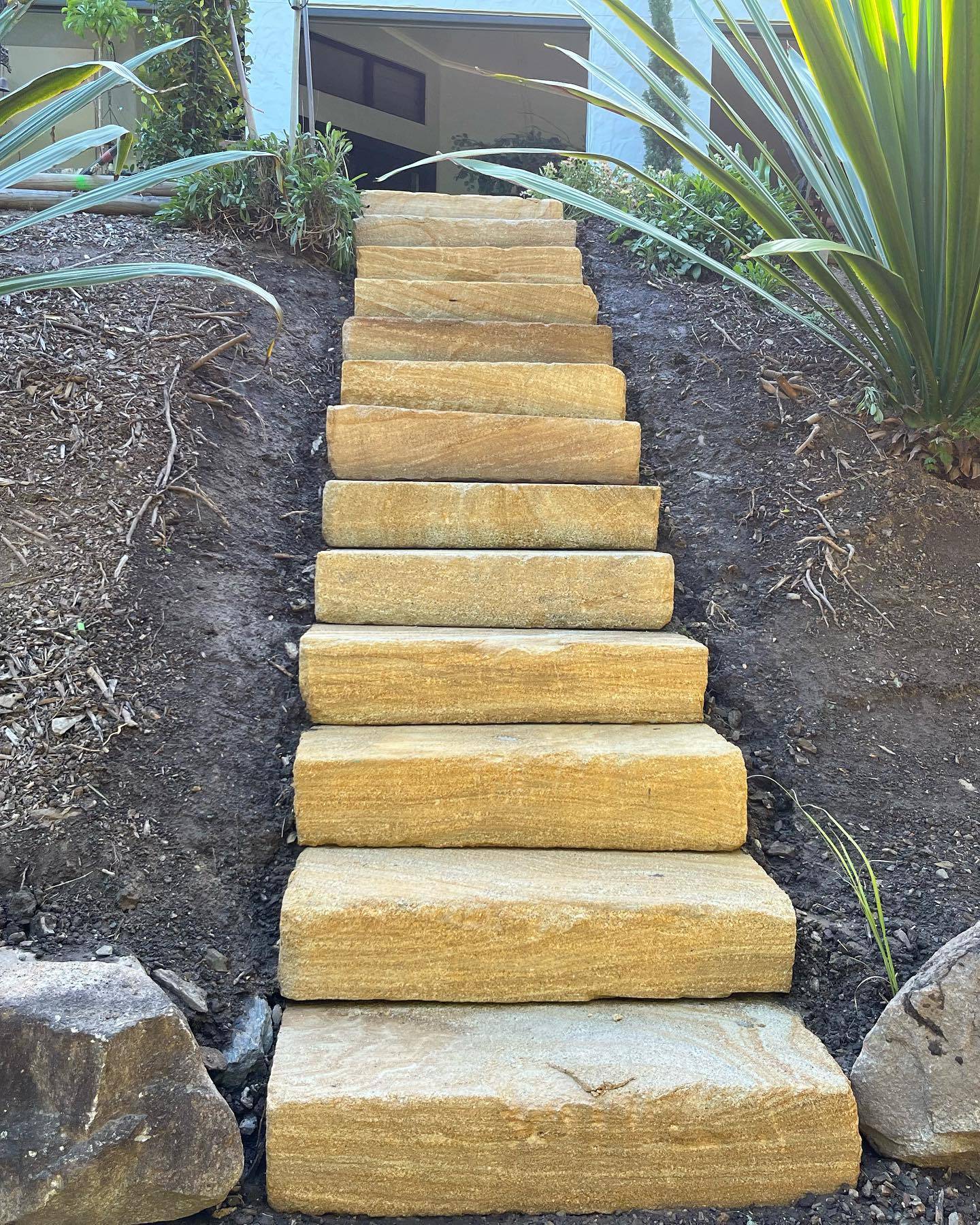 Wheel sawn sandstone steps installation outdoor stairway