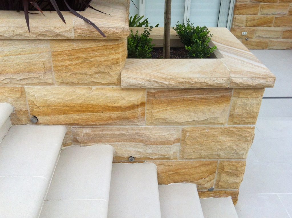 Rockface stone walling with capping stones